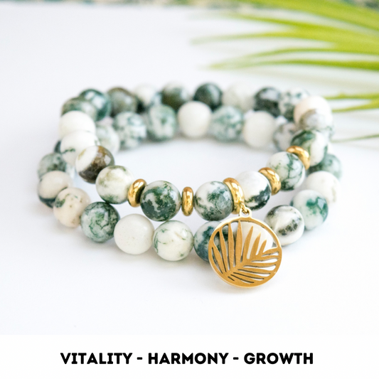 Tree agate stack bracelet for vitality, harmony, growth. Tree agate is a beautiful green and white crystal. The stack has two piece of tree agate bracelet. One of them is with gold colour tropical leaf charm ans gold colour stainless steel spacers between beads. The second bracelet is a simple style made from 8 mm crystals.